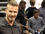 Slick David Beckham and son Brooklyn join star-studded crowd at LA Kings win game three of the hockey finals