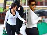 That's not like you! Kim and Khloe Kardashian try to shield their faces from photographers after an early morning workout