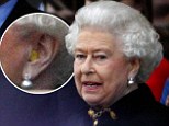 The Queen sensibly wore a pair of foam ear plugs to take in the Jubilee concert at Buckingham Palace last night
